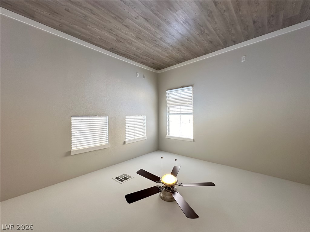 10191 Splendor Ridge Avenue Las Vegas, NV 89135 - Photo 19 of 31 An airy bedroom with a rich wood-paneled ceiling and generous window light.