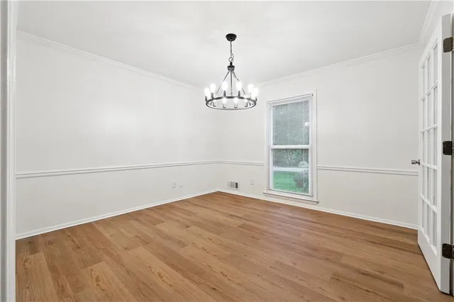 a view of a room with wooden floor and window