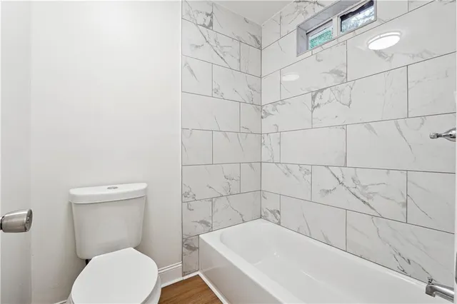 a bathroom with a bathtub and toilet