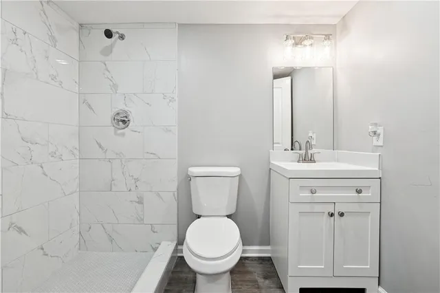 a bathroom with a sink toilet and shower