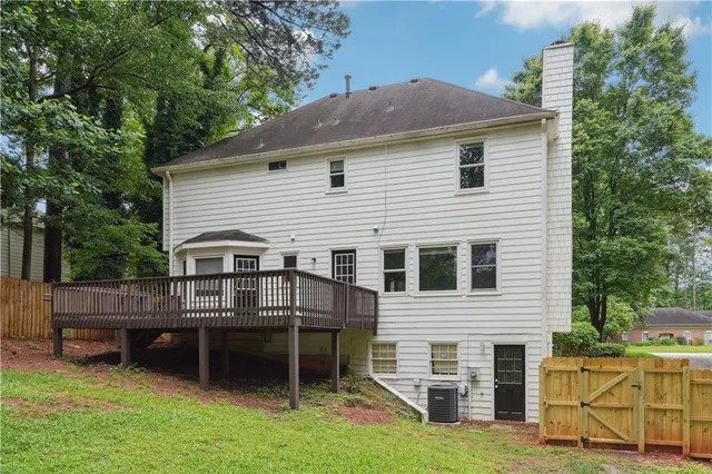 a view of house with yard and sitting area