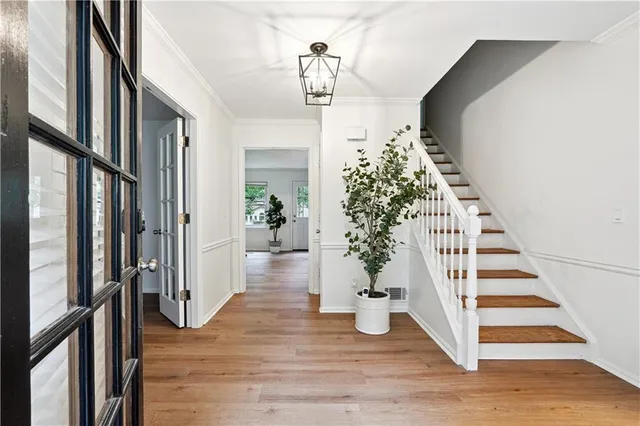 a view of entryway and hall with wooden floor