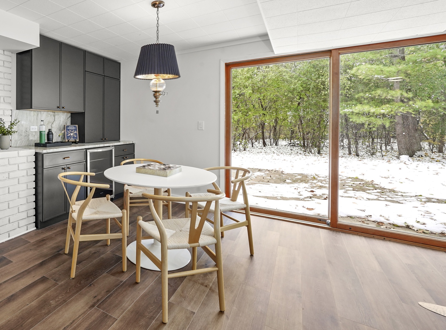 524 Forest Hill Road Lake Forest, IL 60045 - Photo 23 of 32 a dining room with wooden floor a chandelier a glass table and chairs