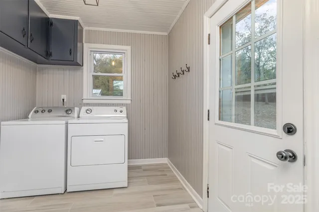 a utility room with cabinets washer and dryer