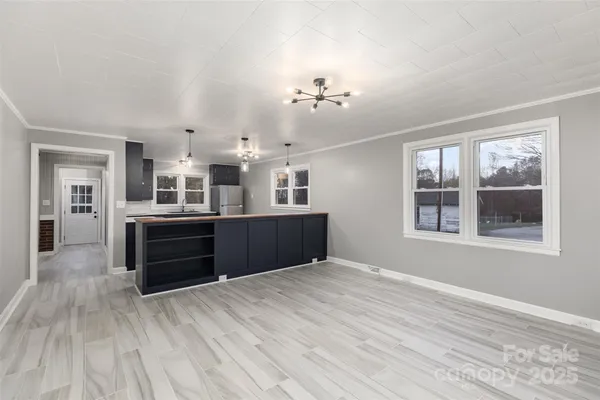 a view of a kitchen with kitchen island wooden floor and window