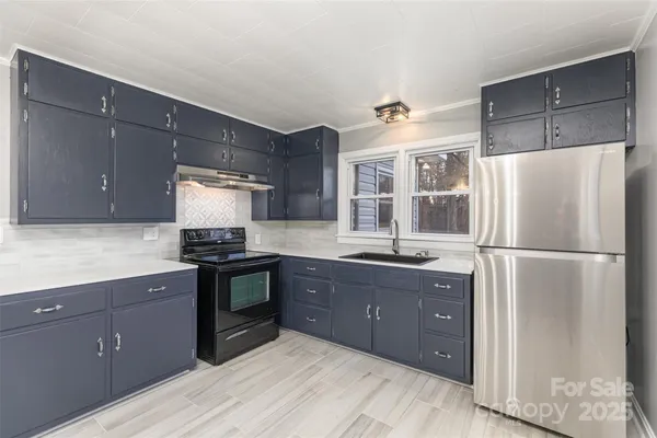 a kitchen with a refrigerator and a sink