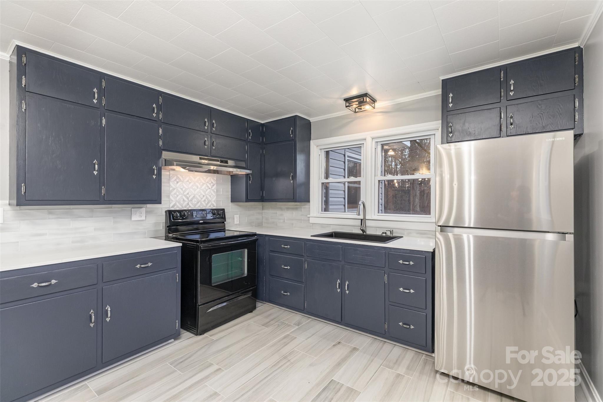 273 Stanley Spencer Mountain Road Gastonia, NC 28056 - Photo 8 of 17 a kitchen with a refrigerator and a sink