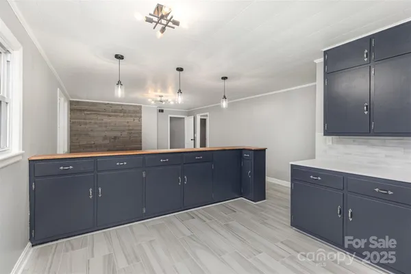 a kitchen with granite countertop a sink and cabinets