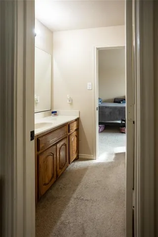 a view of a bathroom with a sink and a mirror