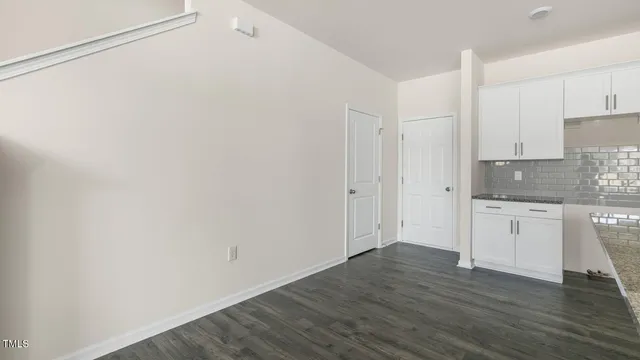 a view of a kitchen with wooden floor and electronic appliances