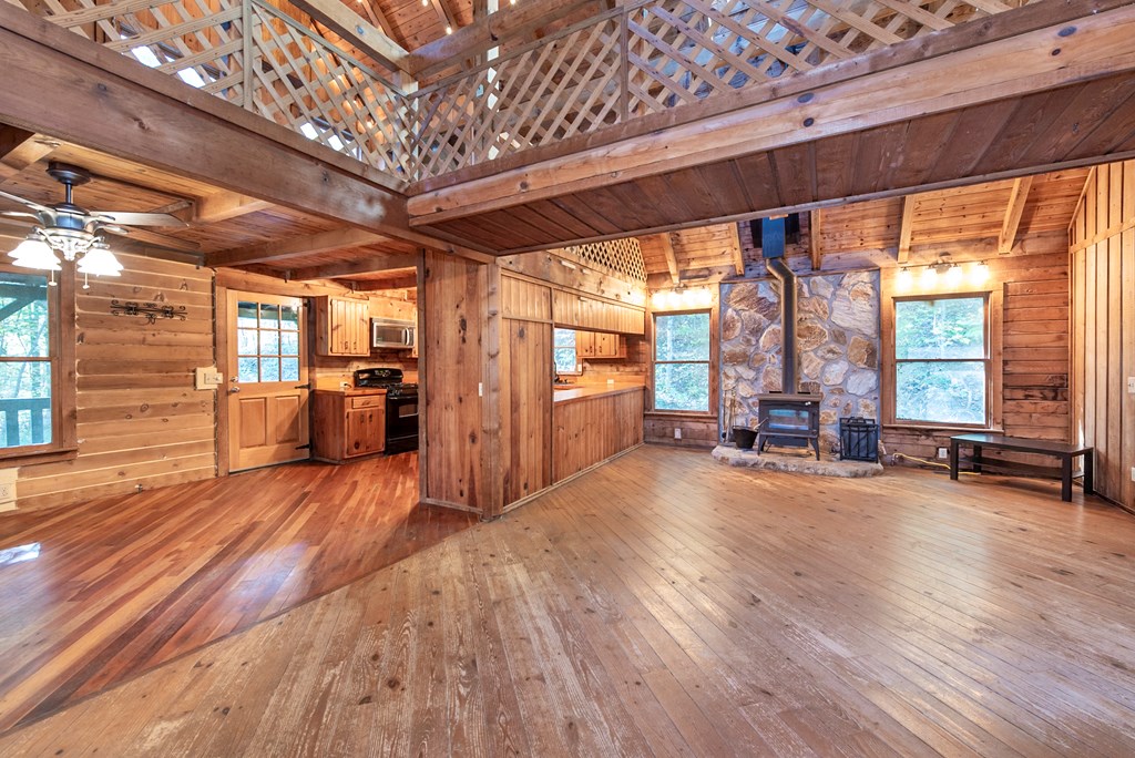 168 Burnt Mountain Cove Road Jasper, GA 30143 - Photo 19 of 53 a big room with wooden floors and furniture
