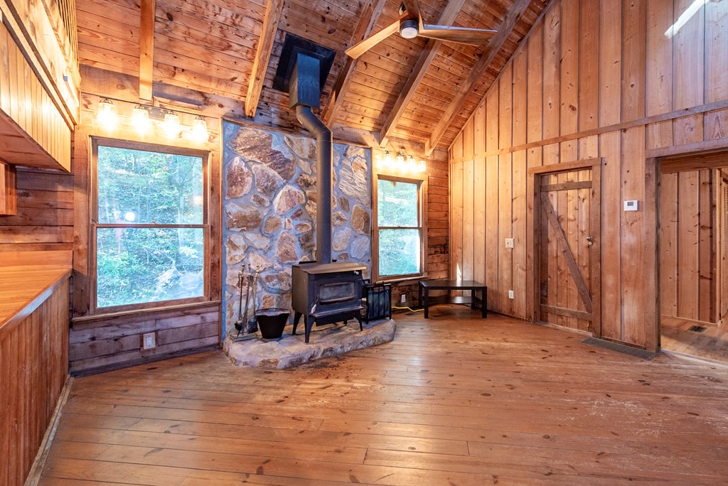 168 Burnt Mountain Cove Road Jasper, GA 30143 - Photo 21 of 53 an empty room with windows and lounge chair