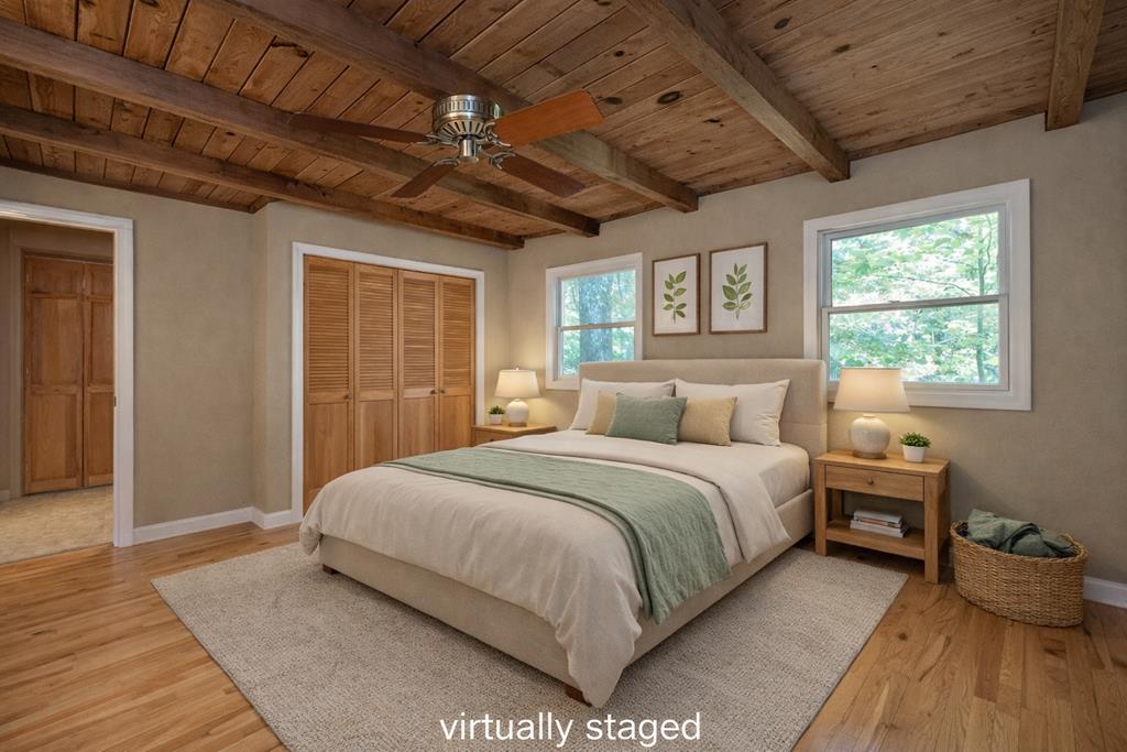 168 Burnt Mountain Cove Road Jasper, GA 30143 - Photo 24 of 53 a spacious bedroom with a bed and a window