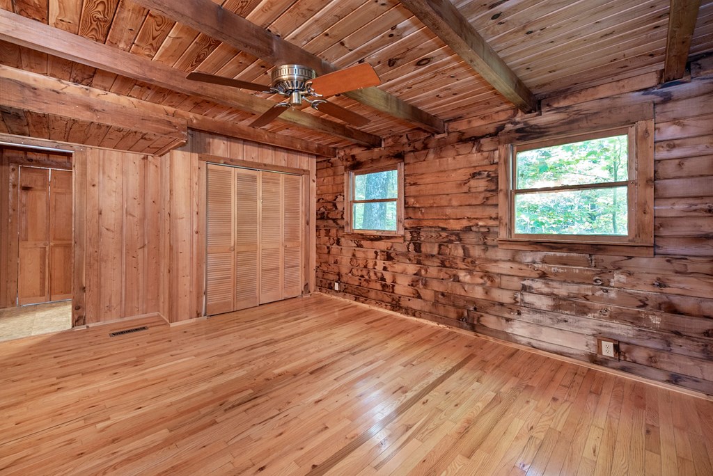168 Burnt Mountain Cove Road Jasper, GA 30143 - Photo 25 of 53 an empty room with wooden floor and windows