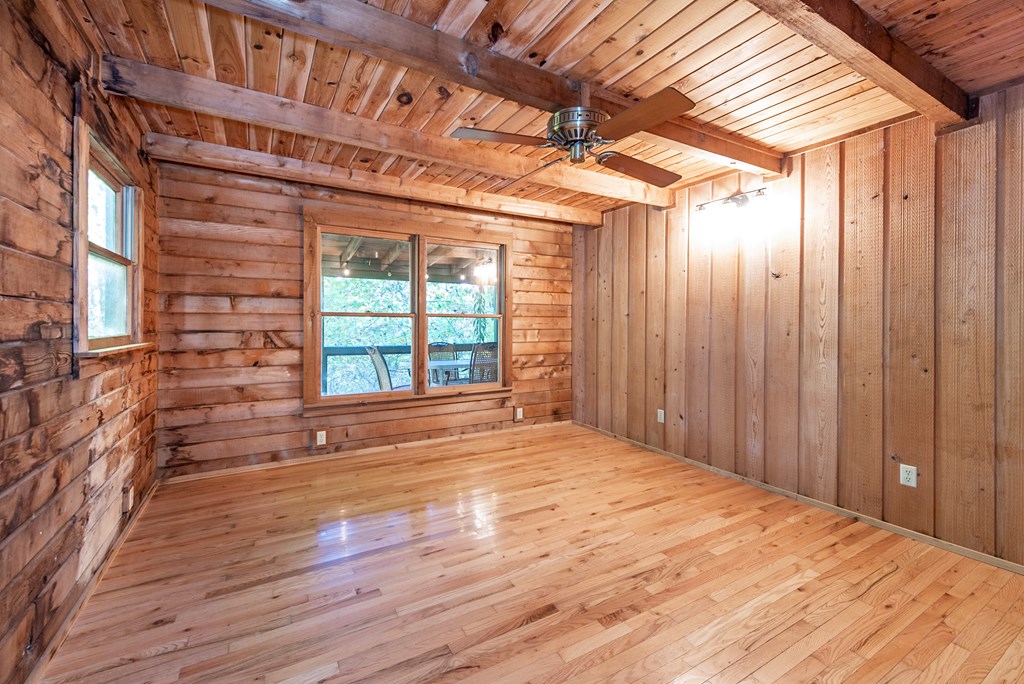 168 Burnt Mountain Cove Road Jasper, GA 30143 - Photo 26 of 53 a view of an empty room with a window and wooden floor