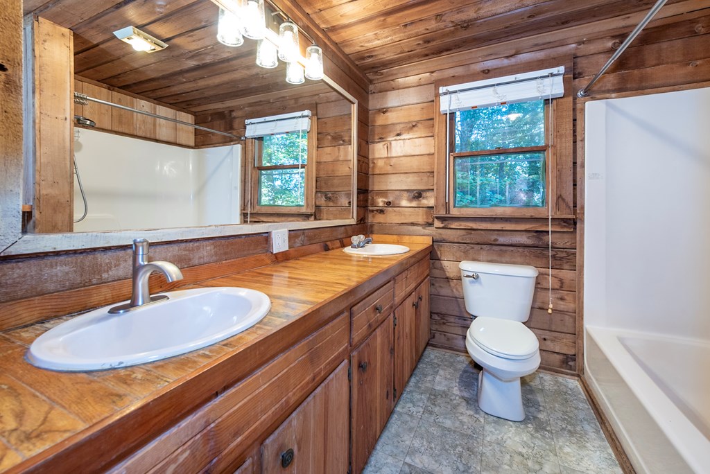 168 Burnt Mountain Cove Road Jasper, GA 30143 - Photo 28 of 53 a bathroom with a granite countertop sink and a mirror