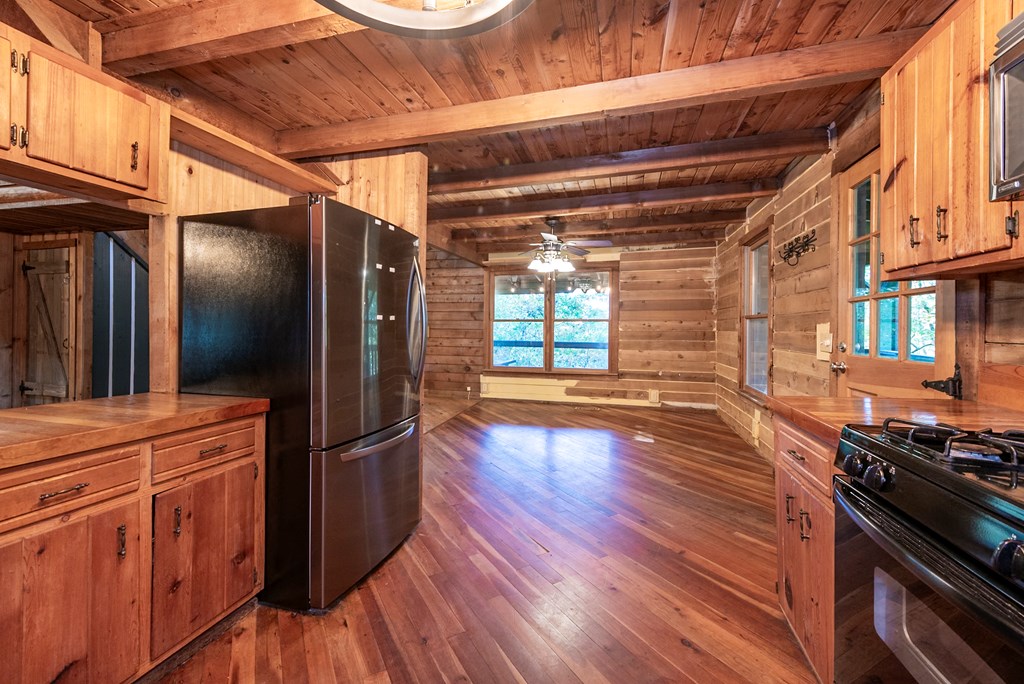 168 Burnt Mountain Cove Road Jasper, GA 30143 - Photo 8 of 53 a view of a refrigerator in kitchen and wooden floor