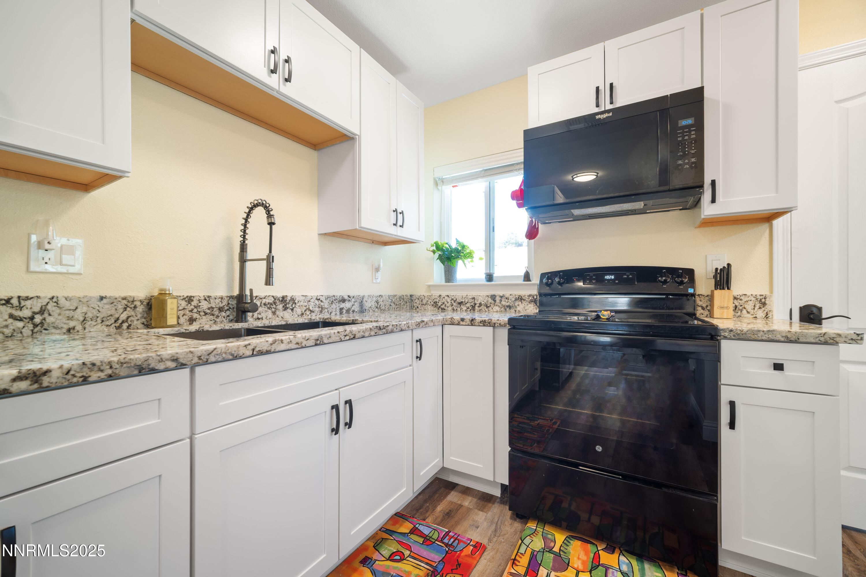 425 Main Street Silver City, NV 89428 - Photo 13 of 27 a kitchen with a sink stove and microwave