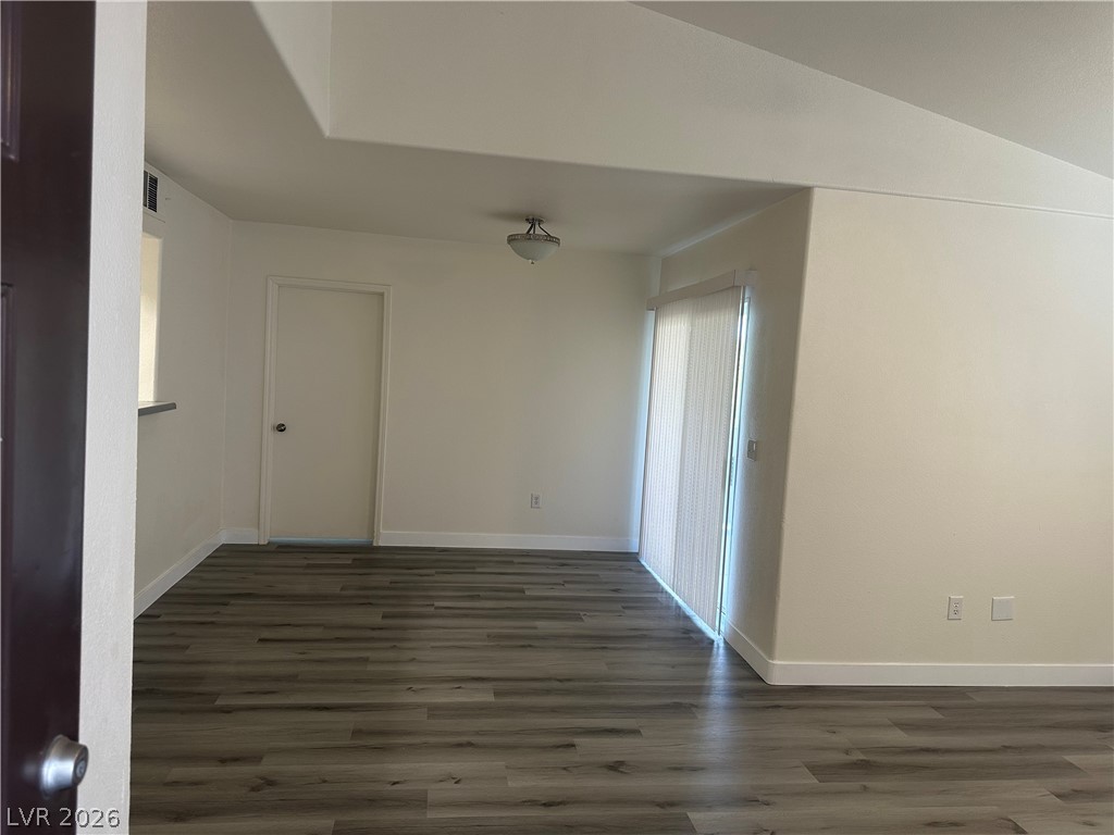 7255 West Sunset Road, Unit 2006 Las Vegas, NV 89113 - Photo 10 of 24 Laminate flooring throughout highlights a spacious room with a sliding door for abundant illumination.