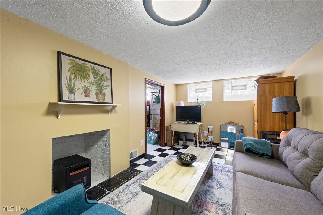 5100 Edenhurst Road Cleveland, OH 44124 - Photo 26 of 35 Living area with a textured ceiling and tile patterned floors