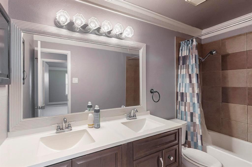 2240 Tarpley Road, Unit 464 Carrollton, TX 75006 - Photo 12 of 18 a bathroom with a sink a toilet and shower