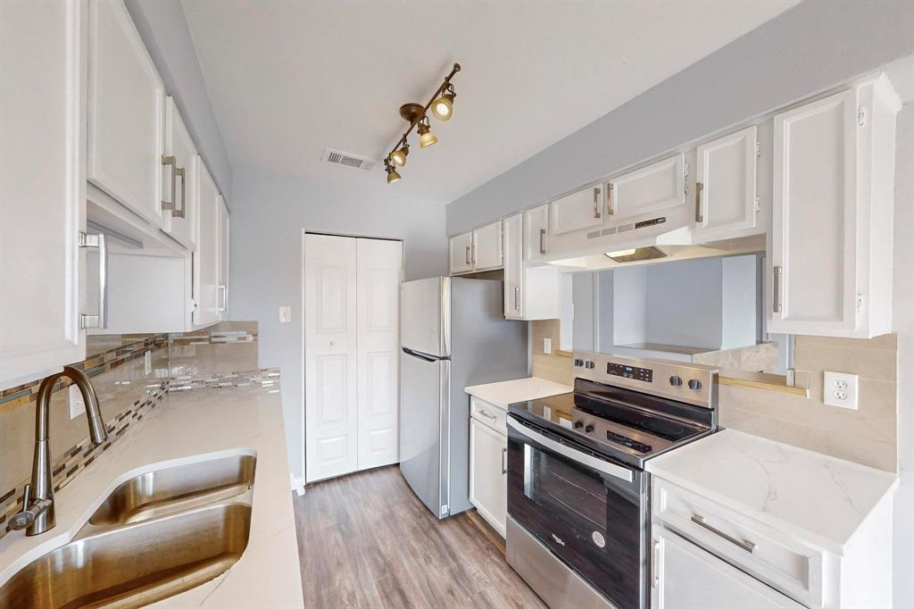 2240 Tarpley Road, Unit 464 Carrollton, TX 75006 - Photo 6 of 18 a kitchen with stainless steel appliances a stove a sink and a refrigerator