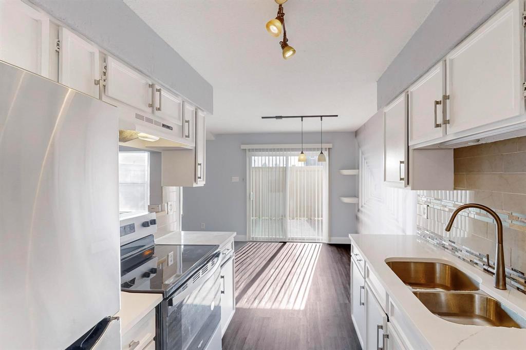 2240 Tarpley Road, Unit 464 Carrollton, TX 75006 - Photo 7 of 18 a kitchen with cabinets a sink and a refrigerator