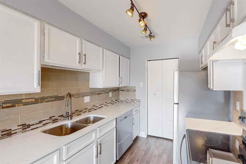 2240 Tarpley Road, Unit 464 Carrollton, TX 75006 - Photo 8 of 18 a kitchen with a sink a stove and cabinets