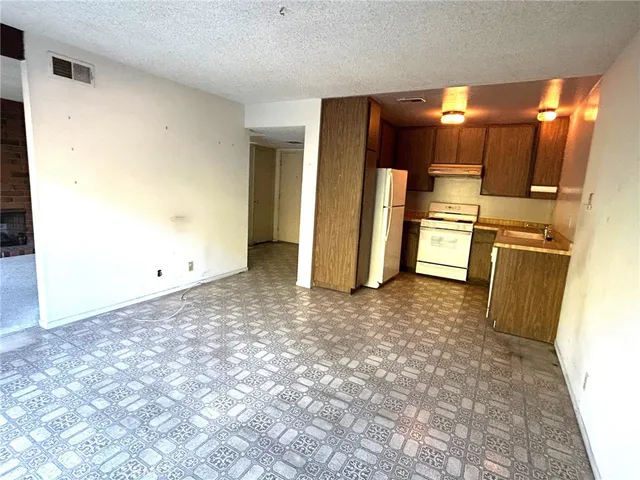 a view of a refrigerator in kitchen and wooden floor