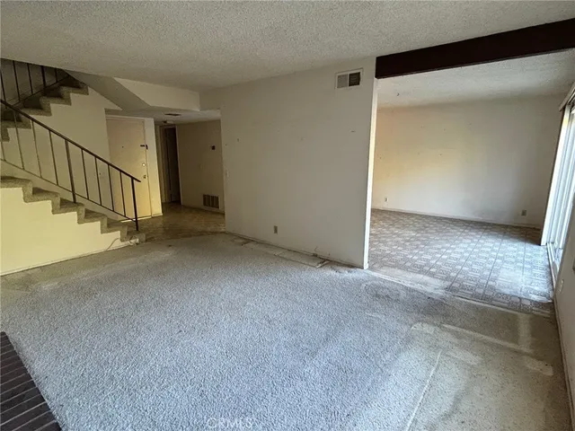 a view of an empty room with stairs