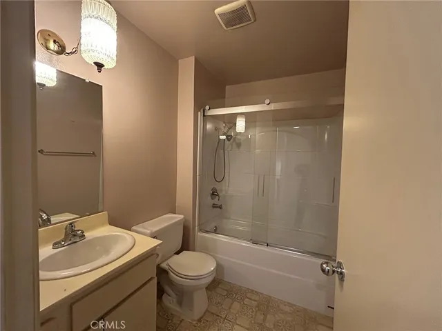 a bathroom with a toilet a sink and shower