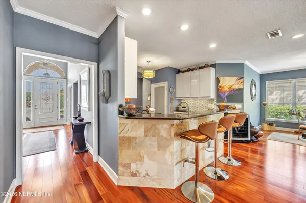 a view of a living room kitchen and a wooden floor