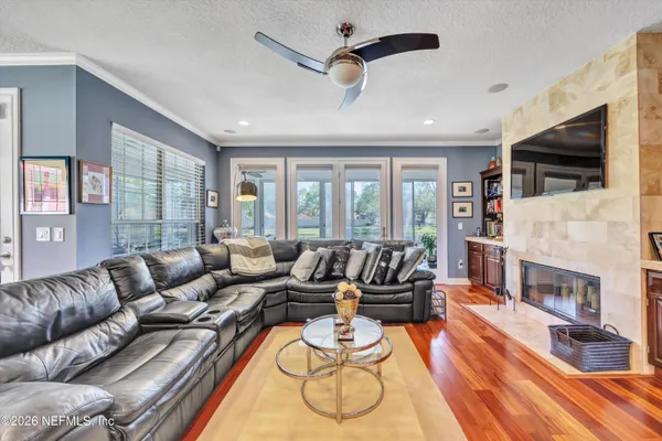 a living room with fireplace furniture and a flat screen tv