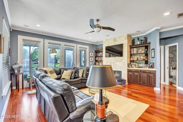 a living room with furniture and wooden floor