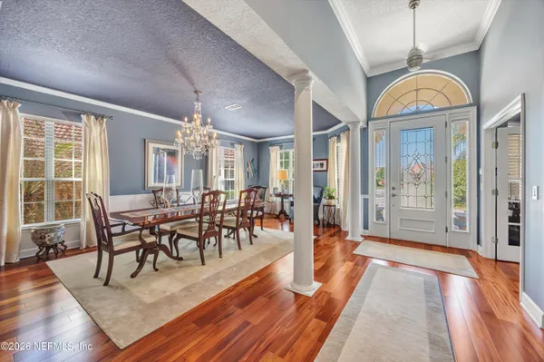 a view of a dining room with furniture window and wooden floor