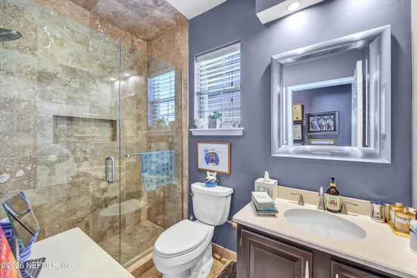 a bathroom with a sink toilet and shower