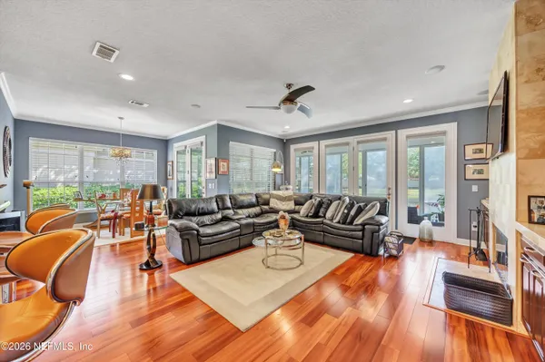 a living room with furniture and wooden floor