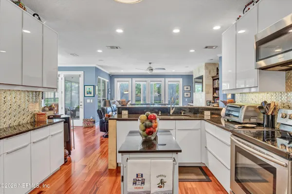 a kitchen with counter top space a sink appliances and cabinets