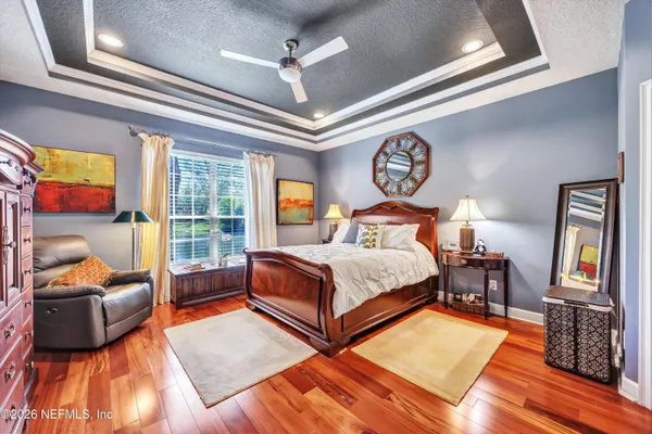 a bedroom with a bed and glass door