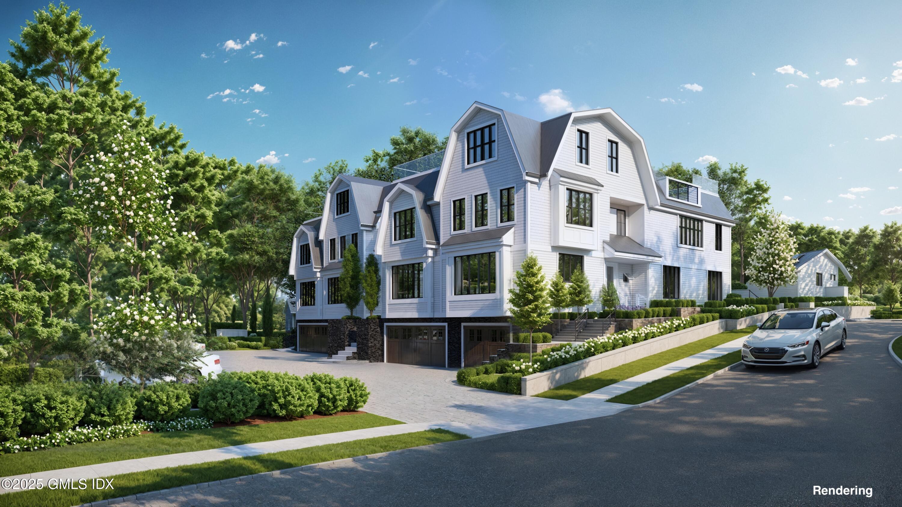 a front view of residential houses with yard and green space