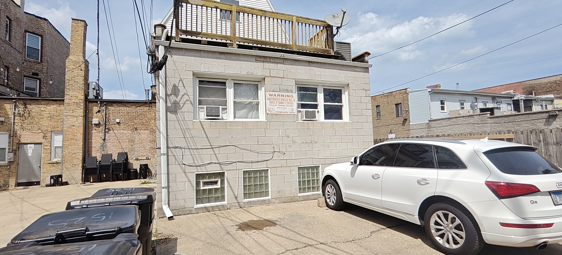 1523 West Devon Avenue Chicago, IL 60660 - Photo 4 of 5 a car parked in front of a brick house