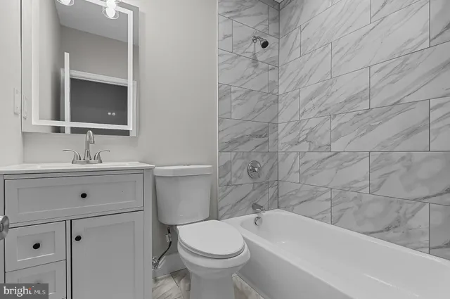a bathroom with a sink toilet and bathtub