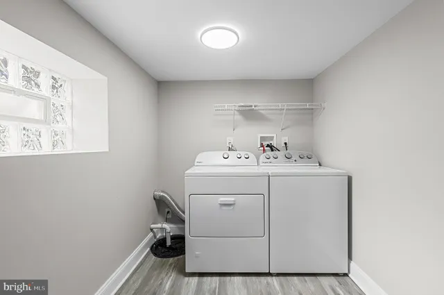 a utility room with cabinets washer and dryer