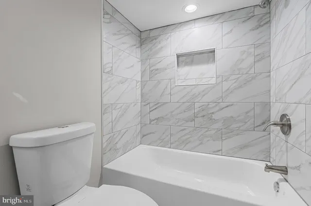 a bathroom with a toilet and a bathtub