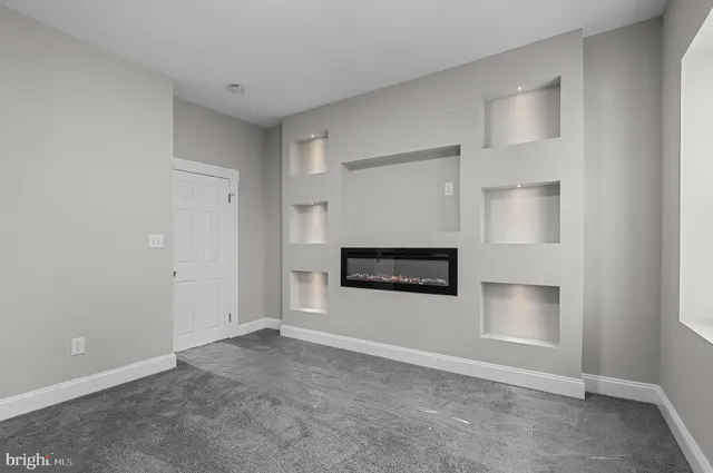 a view of a livingroom with a fireplace and a window