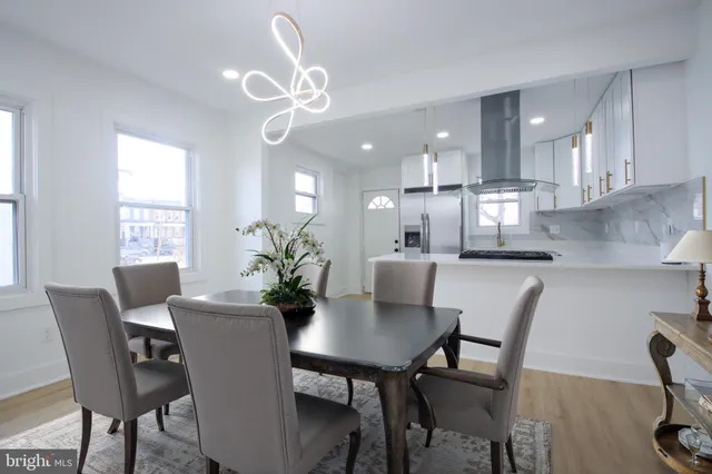 a view of a dining room with furniture and a chandelier