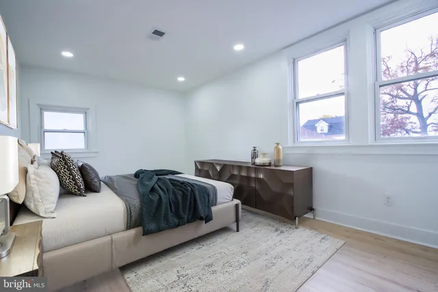 a bedroom with two beds and a large window