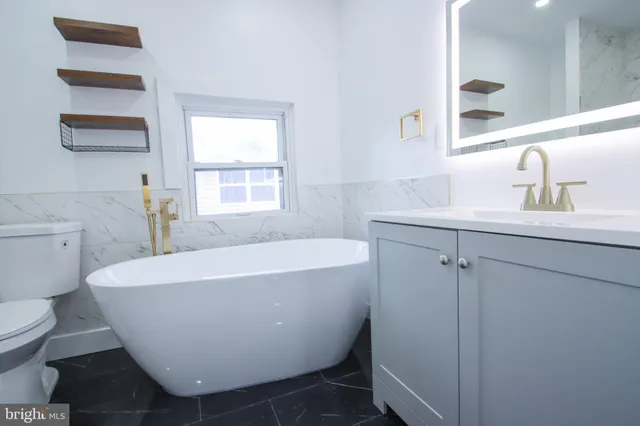a white bath tub sitting next to a white toilet