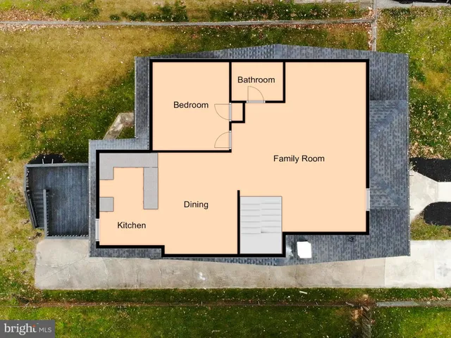 an aerial view of a house with a yard and lake view