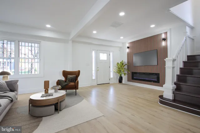 a living room with furniture a fireplace and a flat screen tv